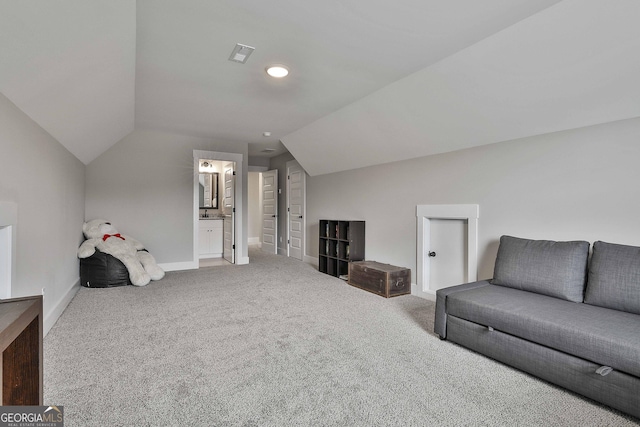 interior space with carpet and vaulted ceiling