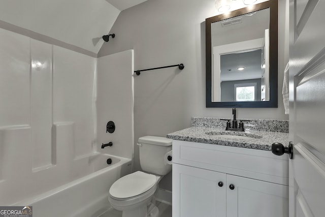 full bathroom featuring washtub / shower combination, toilet, lofted ceiling, and vanity