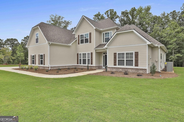 view of front facade featuring a front yard and central AC unit