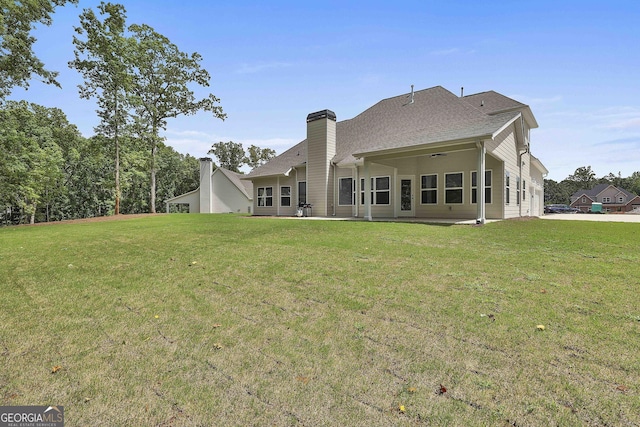 back of house featuring a yard