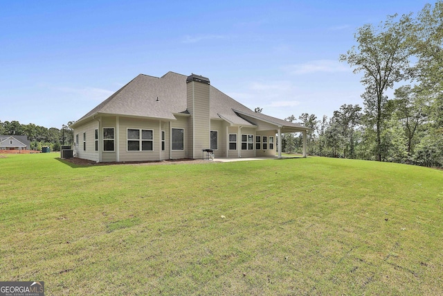 back of property featuring a yard, a patio area, and central air condition unit