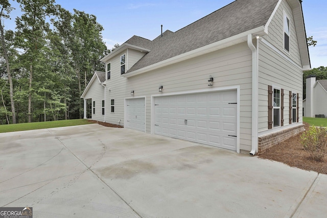 view of side of home featuring a garage