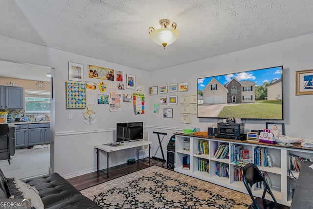 playroom with a textured ceiling and hardwood / wood-style flooring