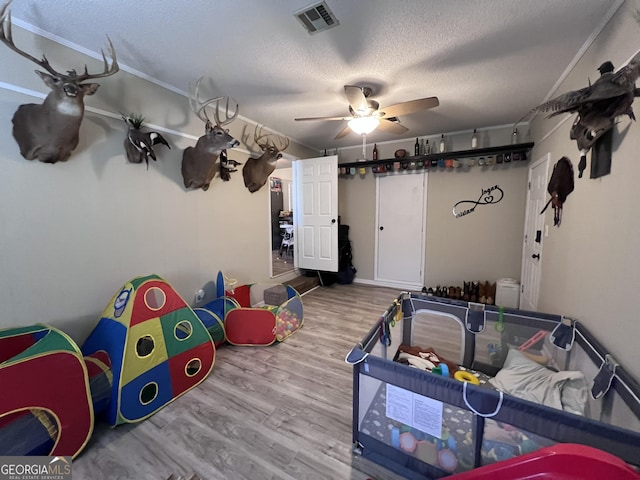 interior space with hardwood / wood-style flooring, ceiling fan, and a textured ceiling