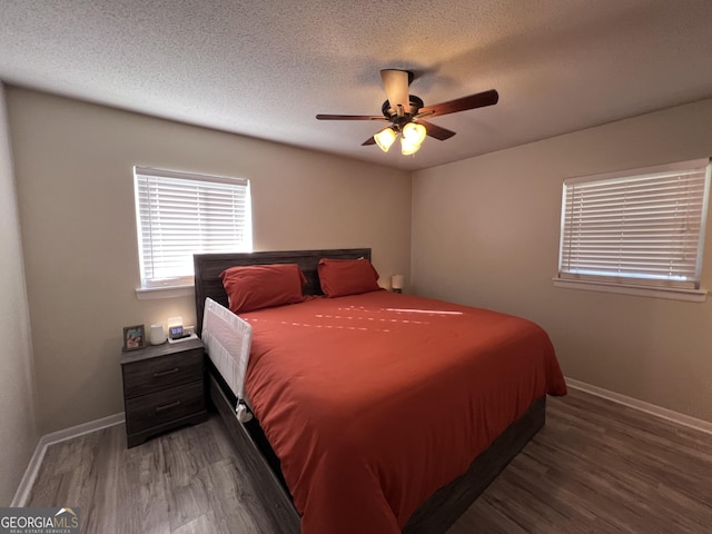 bedroom featuring ceiling fan, wood-type flooring, and a textured ceiling