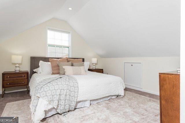 bedroom featuring light carpet and vaulted ceiling