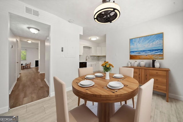 dining room featuring light hardwood / wood-style floors and sink