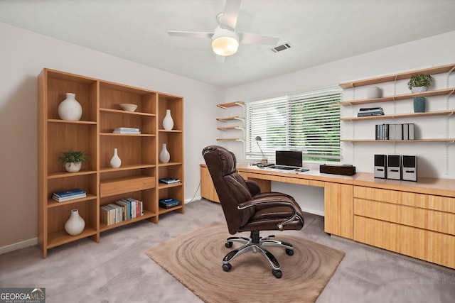 carpeted home office with ceiling fan