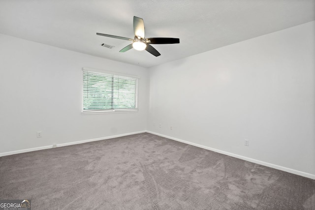 empty room featuring carpet floors and ceiling fan