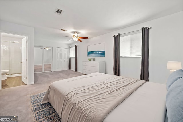 carpeted bedroom with connected bathroom and ceiling fan