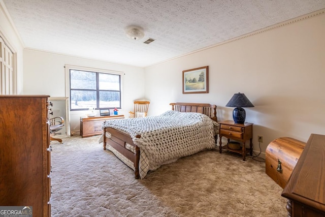 carpeted bedroom with a textured ceiling and ornamental molding