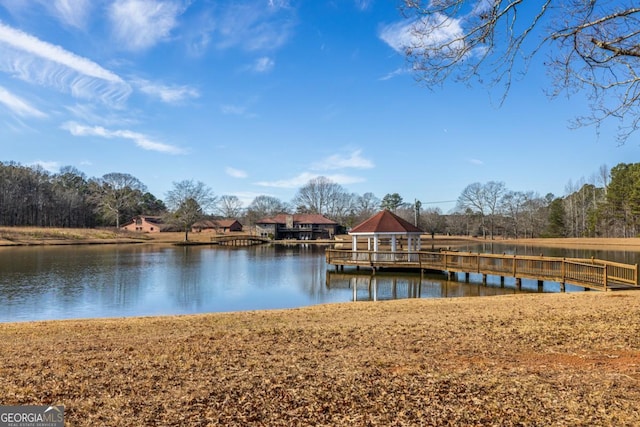 view of dock featuring a gazebo and a water view