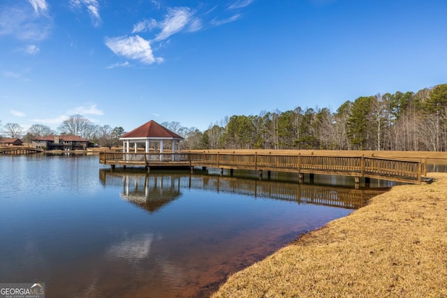 view of dock with a gazebo and a water view