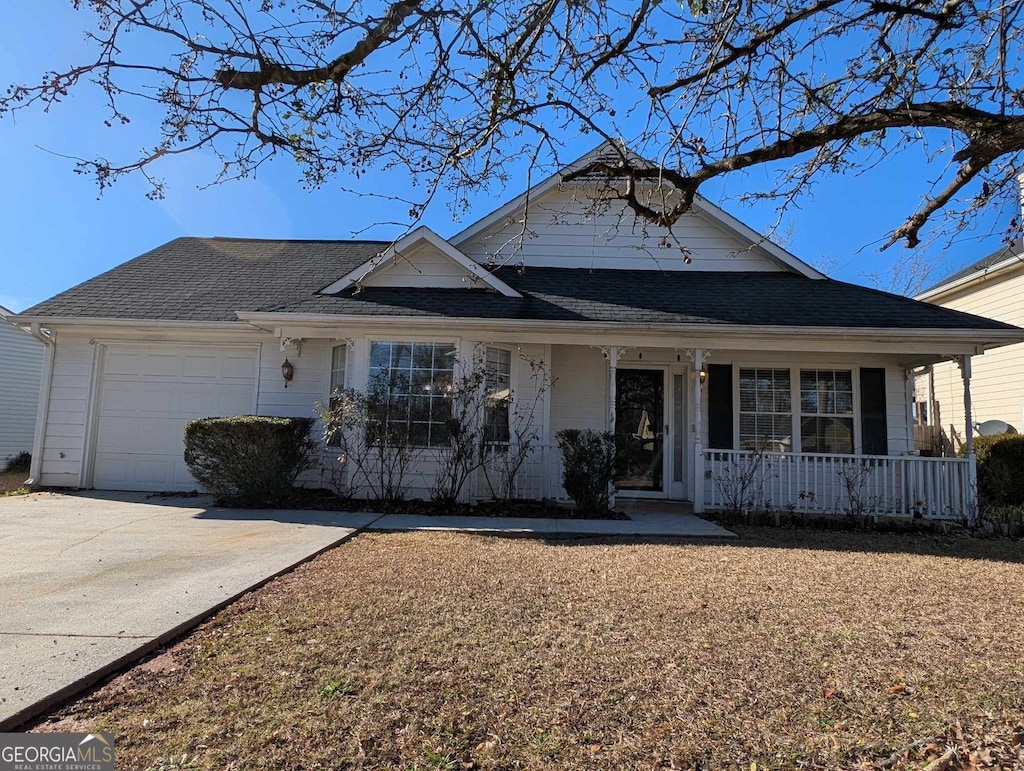 view of front of property featuring covered porch and a garage