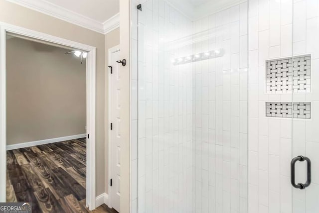 bathroom featuring hardwood / wood-style floors, an enclosed shower, and ornamental molding