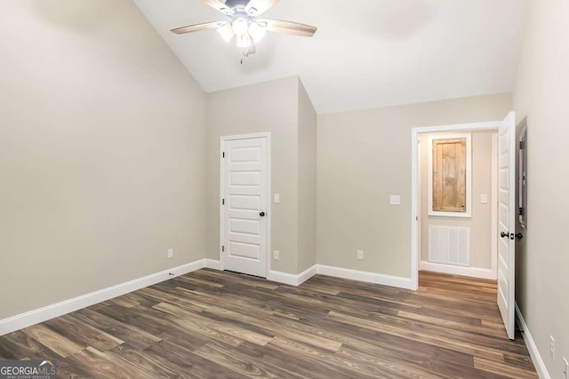 unfurnished bedroom with ceiling fan, lofted ceiling, and dark wood-type flooring