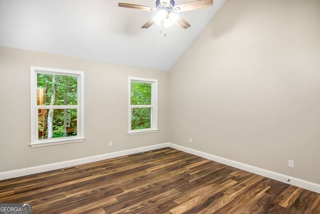 unfurnished room featuring plenty of natural light, ceiling fan, lofted ceiling, and dark wood-type flooring