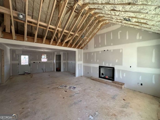 unfurnished living room with vaulted ceiling