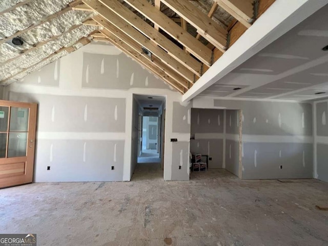 unfurnished living room with vaulted ceiling