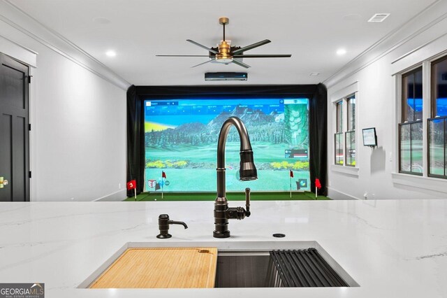 bar featuring light stone countertops, ornamental molding, sink, decorative light fixtures, and light hardwood / wood-style floors