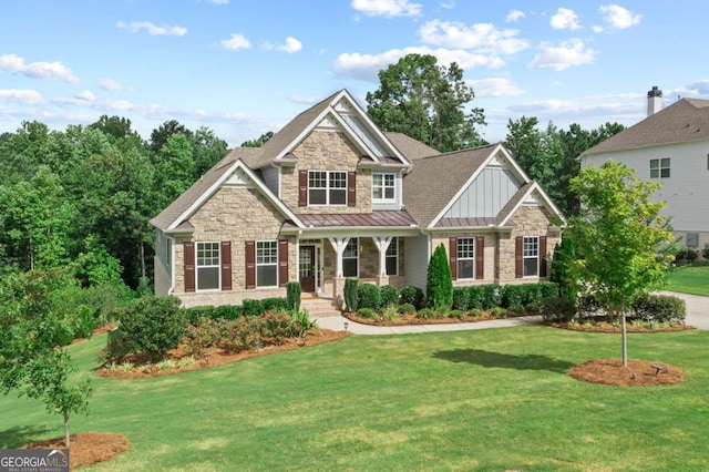 craftsman house with a porch and a front lawn