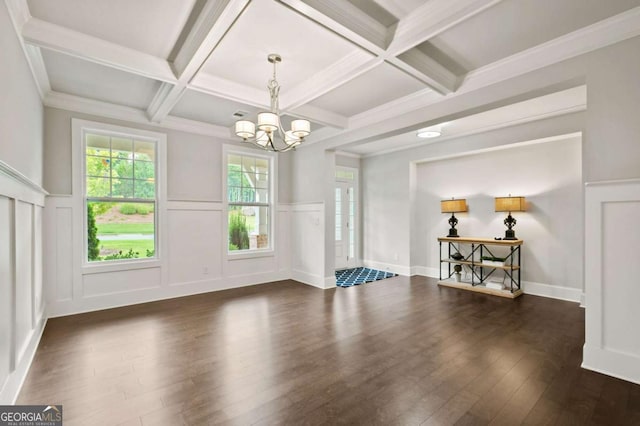 interior space featuring beamed ceiling, coffered ceiling, dark wood-type flooring, and an inviting chandelier