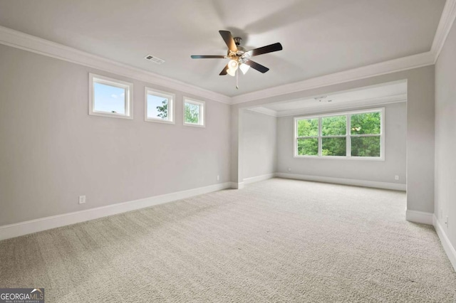 unfurnished room featuring ceiling fan, ornamental molding, and light carpet