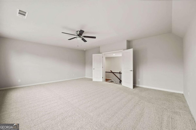 carpeted spare room featuring ceiling fan