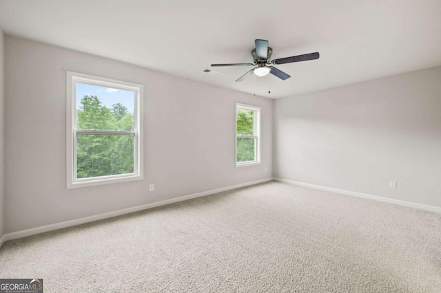 carpeted spare room with ceiling fan