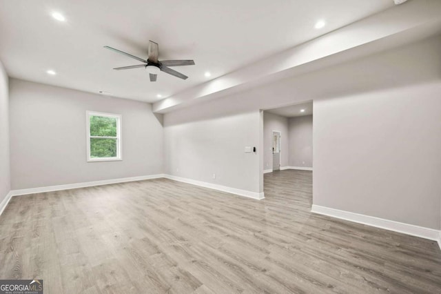 spare room with ceiling fan and light wood-type flooring