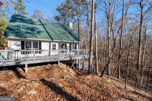 back of house with a wooden deck