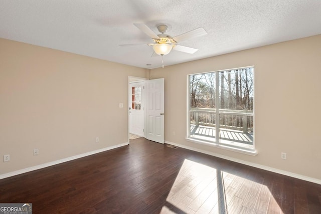 unfurnished room featuring a textured ceiling, ceiling fan, and dark hardwood / wood-style floors