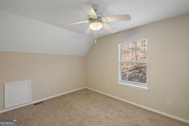 bonus room featuring ceiling fan, light carpet, and vaulted ceiling