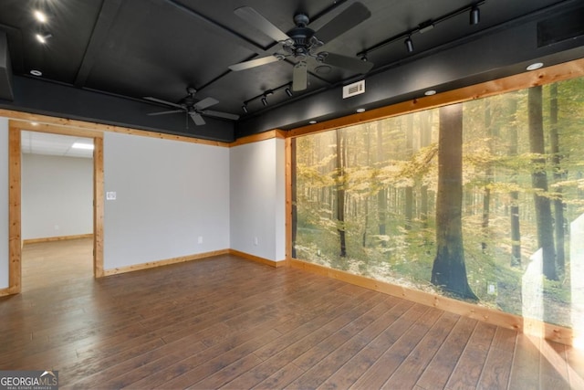 basement with hardwood / wood-style flooring, track lighting, and ceiling fan