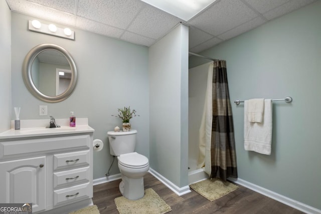 bathroom featuring walk in shower, a paneled ceiling, vanity, and hardwood / wood-style flooring