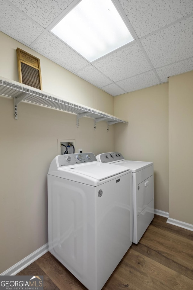 laundry room featuring independent washer and dryer and dark wood-type flooring