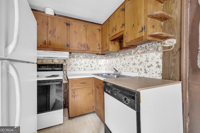 kitchen with decorative backsplash, sink, and white appliances