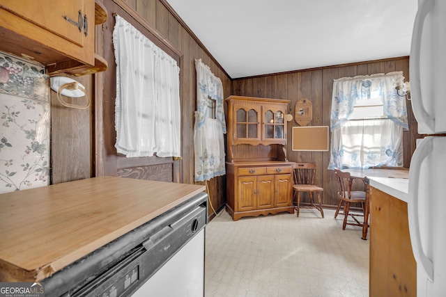 interior space featuring crown molding and wooden walls