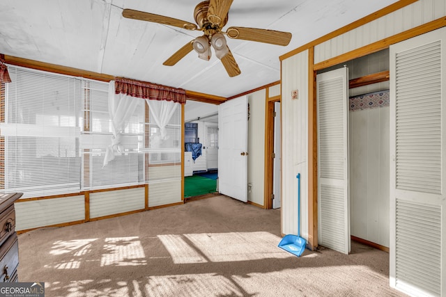 unfurnished bedroom featuring ceiling fan, a closet, and light colored carpet