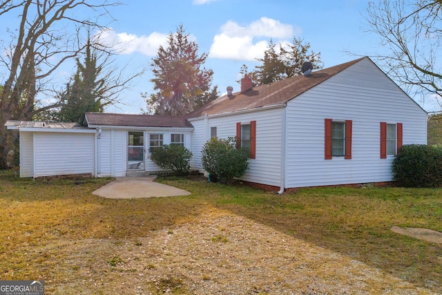 back of property with a lawn