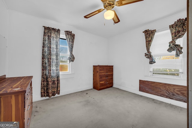 unfurnished bedroom with multiple windows, light colored carpet, and ceiling fan