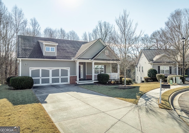 view of front facade with a porch, a garage, and a front yard