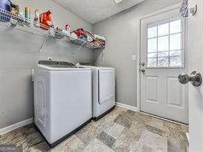 laundry area featuring washing machine and clothes dryer