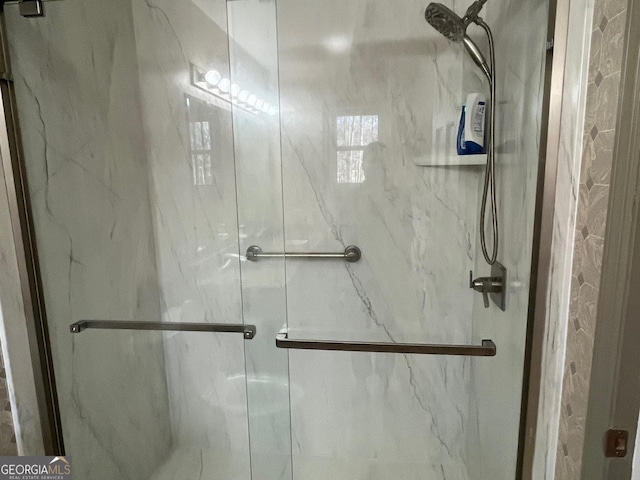 bathroom with a shower with shower door