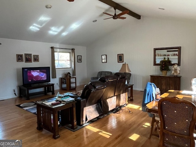 living room featuring lofted ceiling with beams, ceiling fan, and light hardwood / wood-style flooring