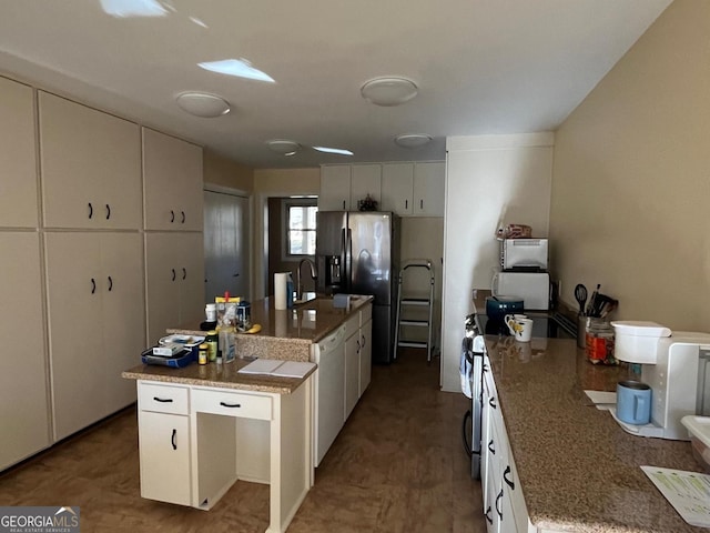 kitchen with sink, white cabinetry, a kitchen island with sink, and stainless steel appliances