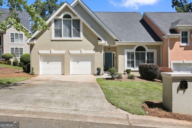 view of front of property with a garage and a front lawn