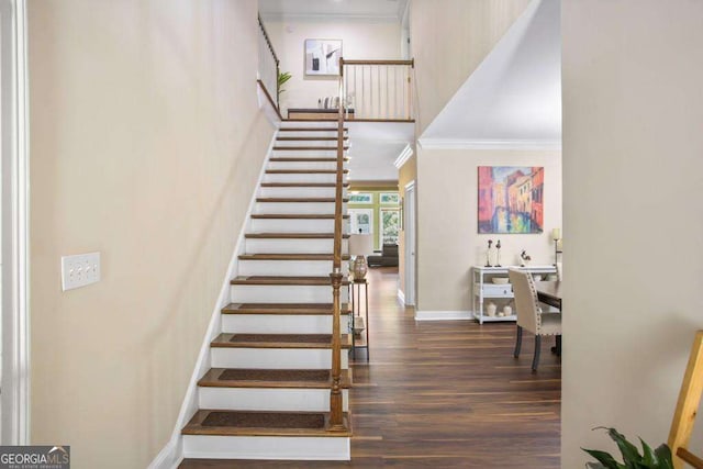 staircase with crown molding and wood-type flooring