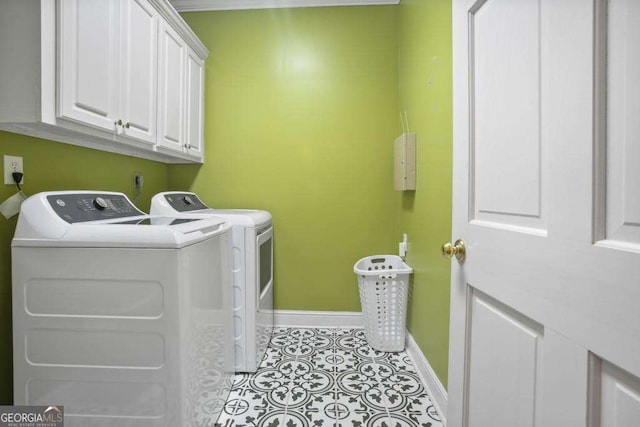 washroom with cabinets and washing machine and clothes dryer