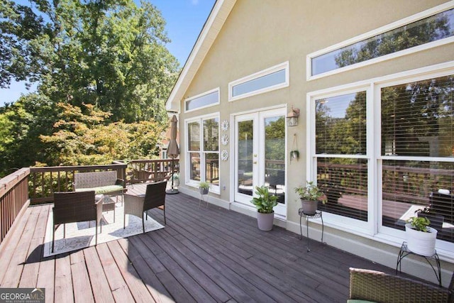 wooden deck featuring french doors and an outdoor hangout area